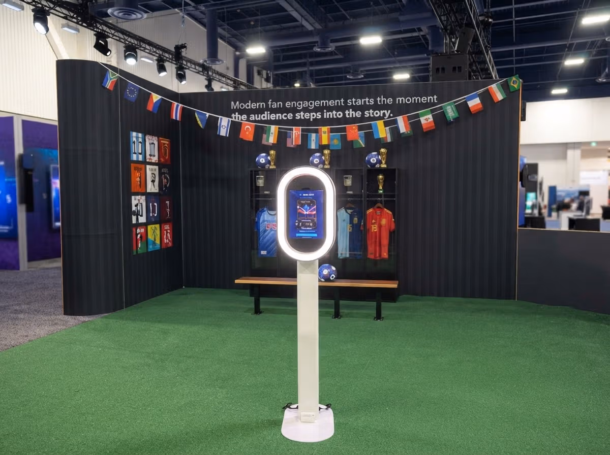 Interactive soccer fan engagement booth with AI trading card kiosk, flags, and jerseys at Infocomm