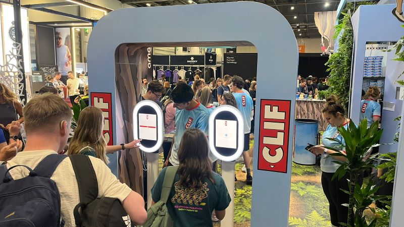 Two CLIF-branded AI photo booth kiosks in use on the CLIF stand at the London Marathon Running Show.