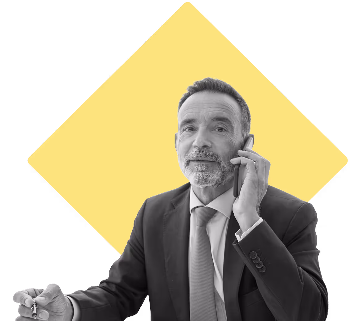 Man in a suit on the phone looking at the camera