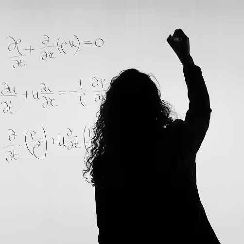 Teacher writing equations on a white board