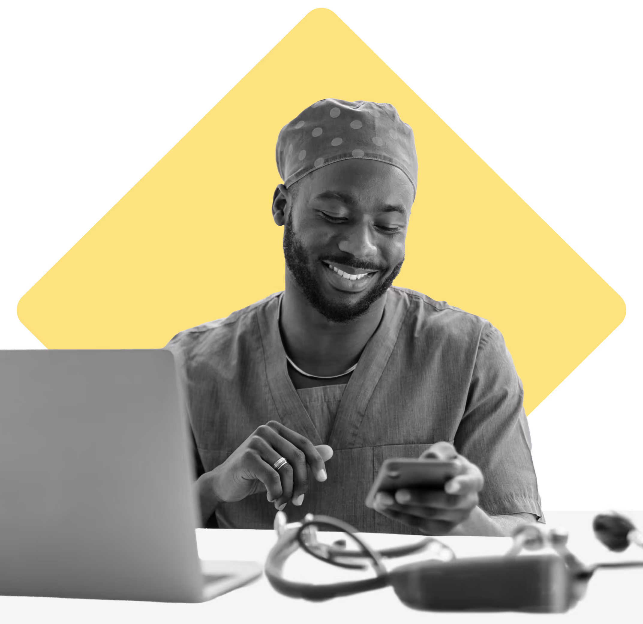 Healthcare worker at a desk, smiling at his phone