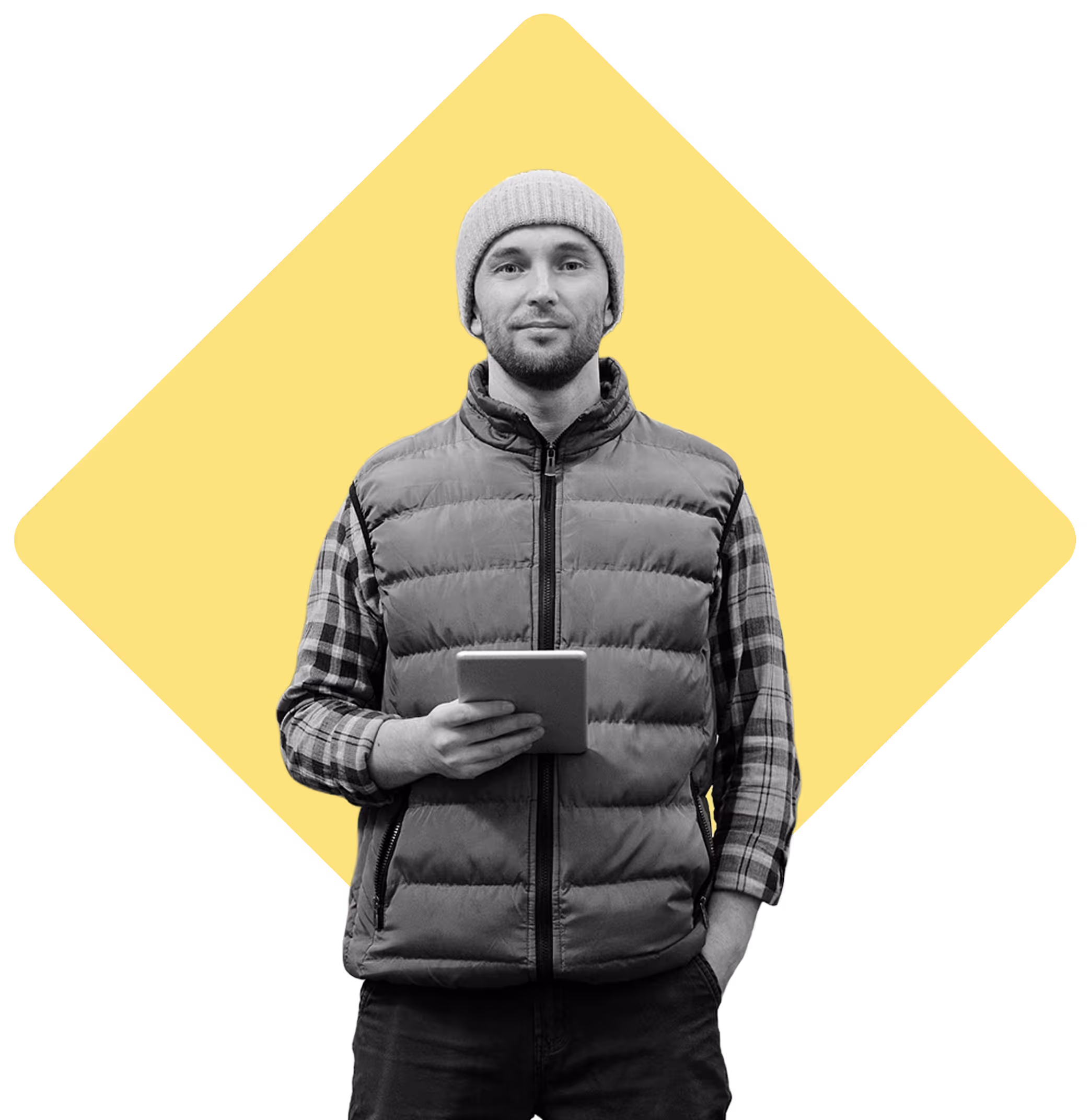 Warehouse worker smiling at camera with a tablet in hand