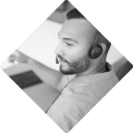 Employee taking a call on his phone headset.