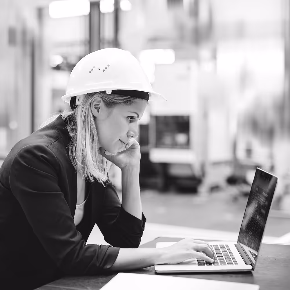 Woman in manufacturing typing on her laptop