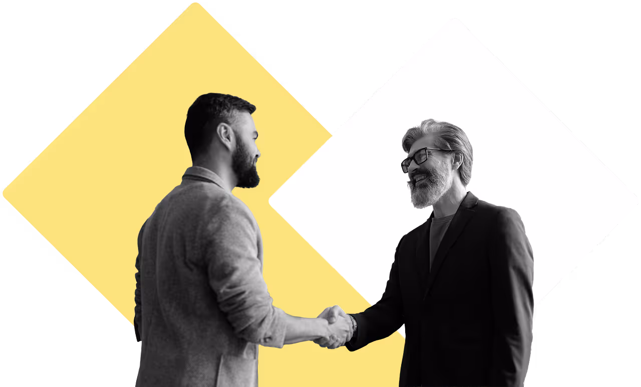 A younger man and an older gentleman shaking hands