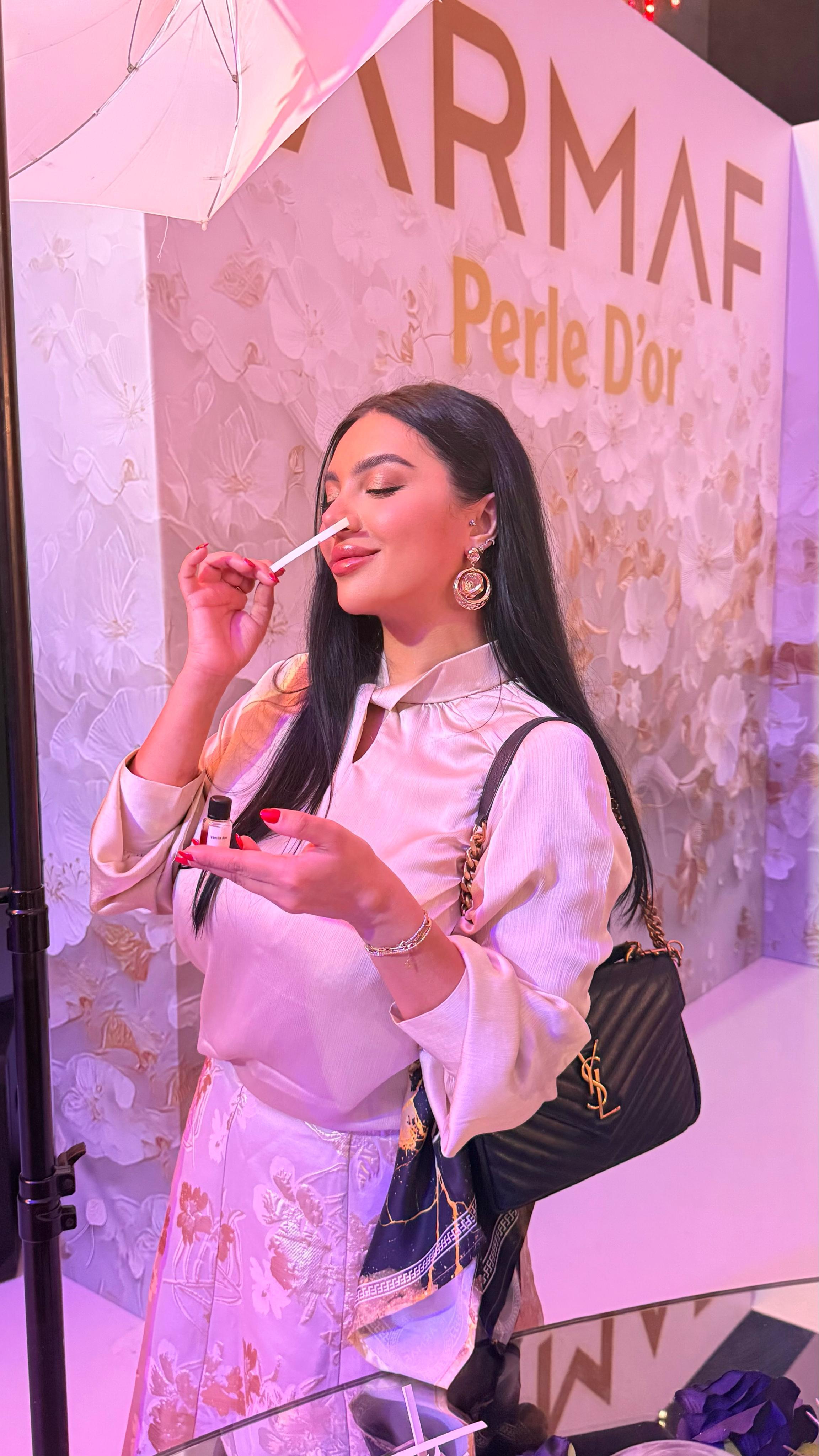 Influencer filming an Instagram Reel at an ARMAF perfume launch event in the UAE