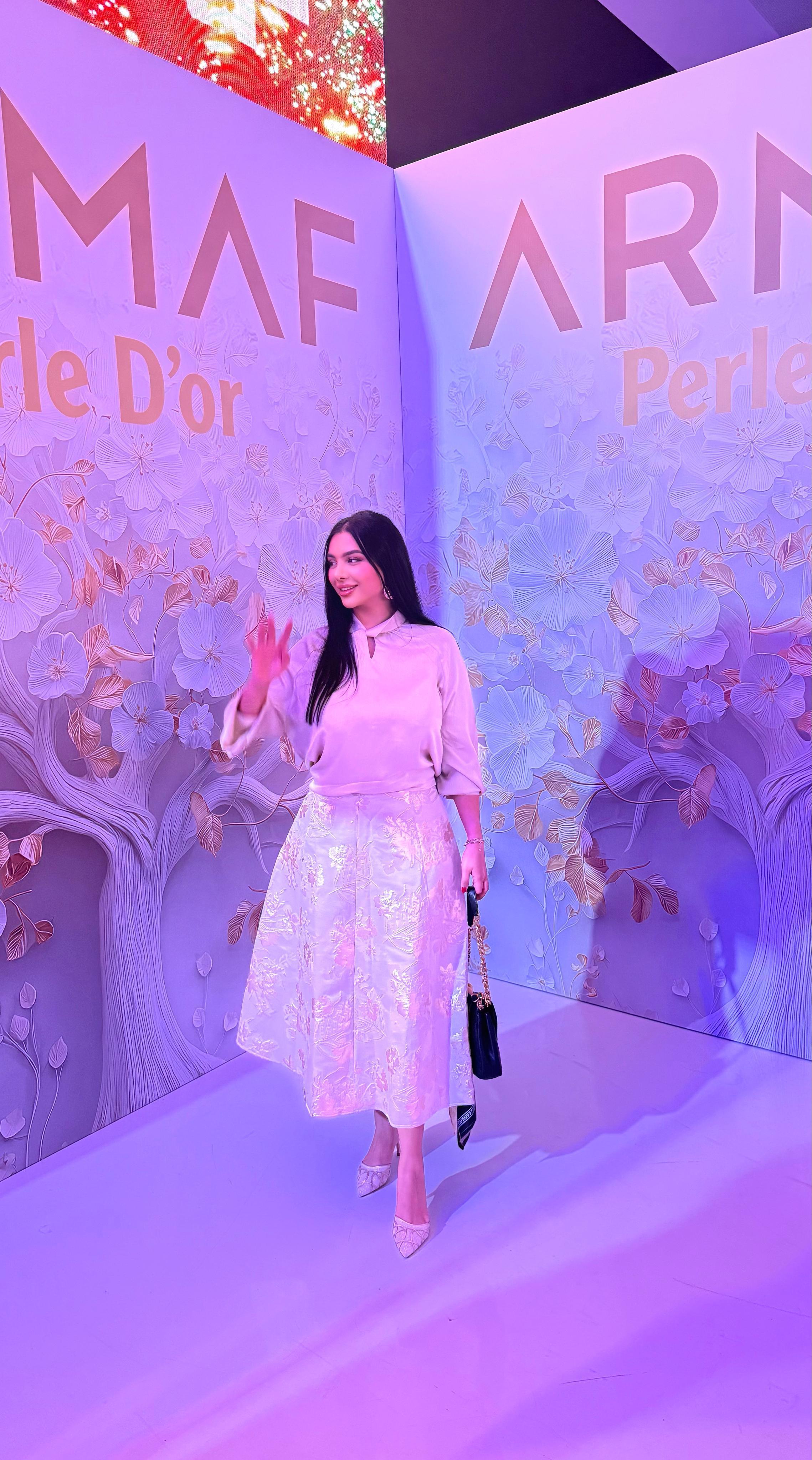 Influencer filming an Instagram Reel at an ARMAF perfume launch event in the UAE