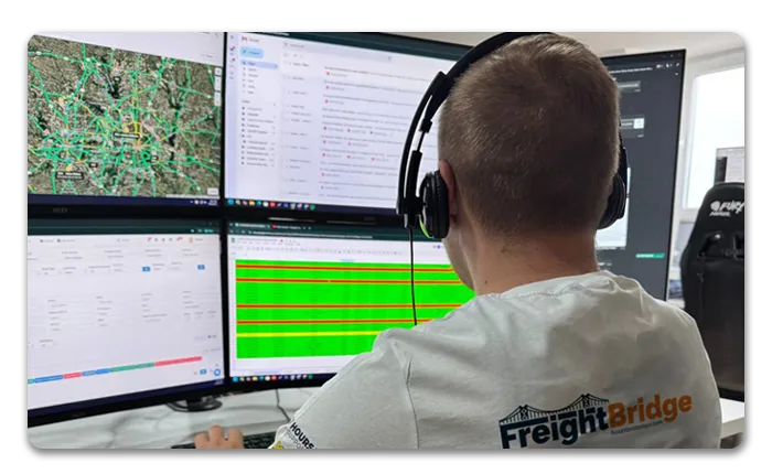 Truck driver filling out paperwork on a clipboard inside the cab, preparing for freight delivery – FreightBridge