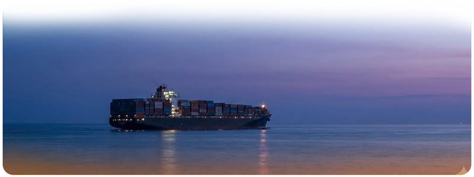 A lone container ship sailing through calm waters at twilight, symbolizing the softening demand and cooling spot rates in the transpacific market.