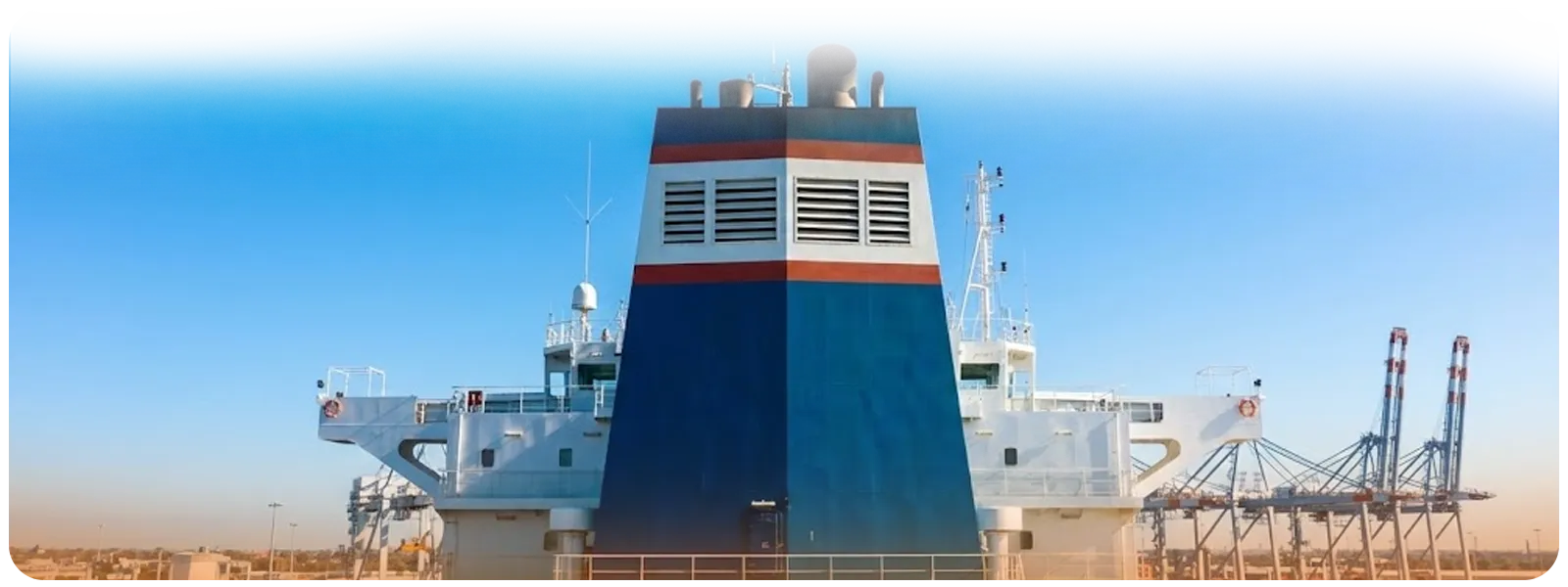 Close-up of a container ship's smokestack against a clear blue sky emitting no smoke, symbolizing the Port of Los Angeles' reduction in harmful emissions.