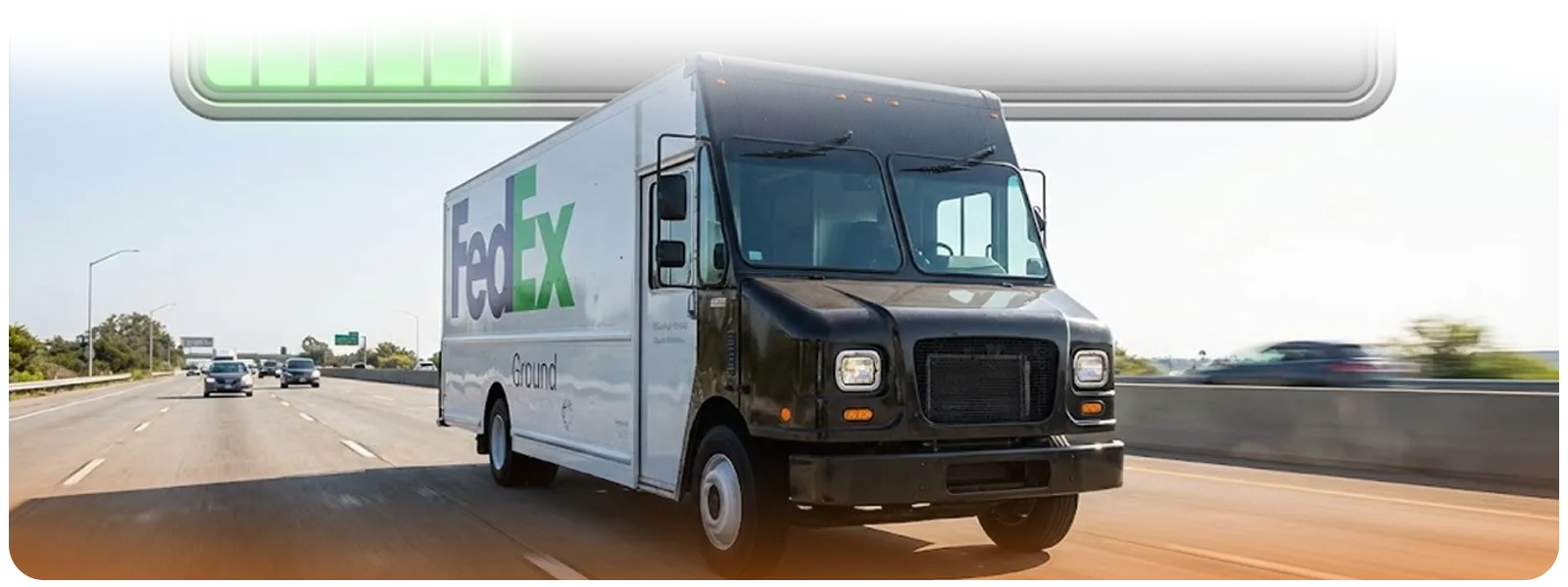 Wide shot of a FedEx Ground electric box truck in transit on an open freeway, paired with a battery indicator showing charging progress.