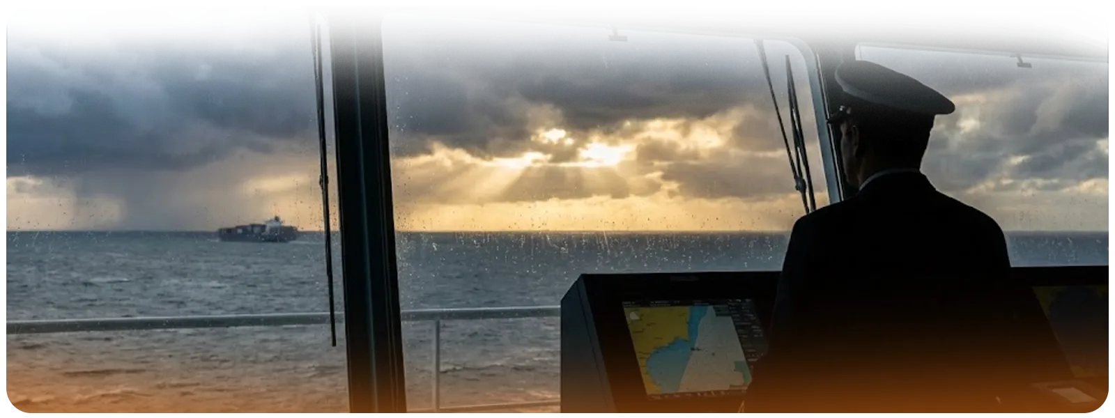 Silhouette of a ship captain on the bridge looking out over rough seas toward a distant vessel under dramatic sunset light.