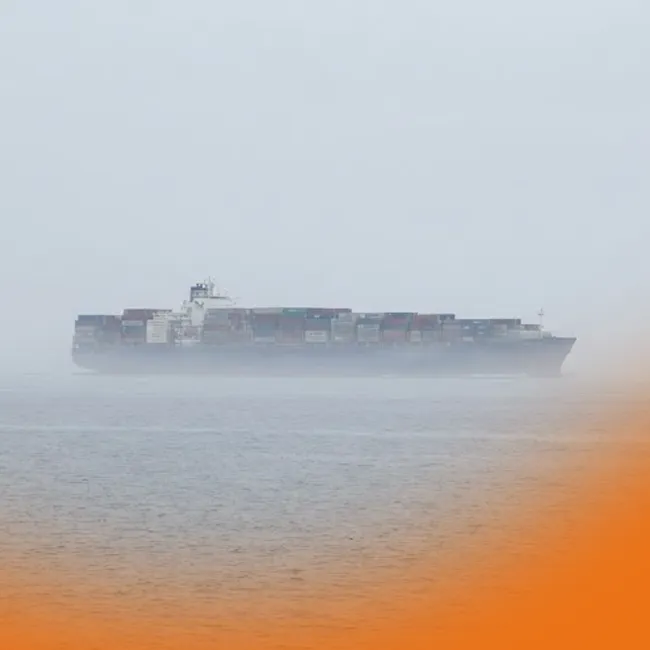 Stacks of colorful shipping containers at a port, illustrating shifting ocean freight demand after peak season.