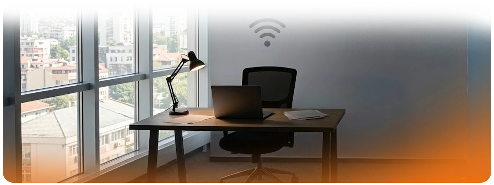 A minimalist workspace featuring a wooden desk, black office chair, and open laptop in front of a gray wall with a Wi-Fi icon. A desk lamp illuminates papers on the left, while large glass windows show an urban city view in the background. An orange light 