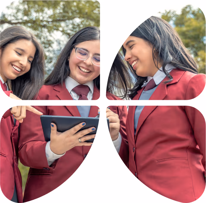 3 chicas sonrientes en uniforme escolar mirando una tableta que esta usando la chica en el centro con un lapíz