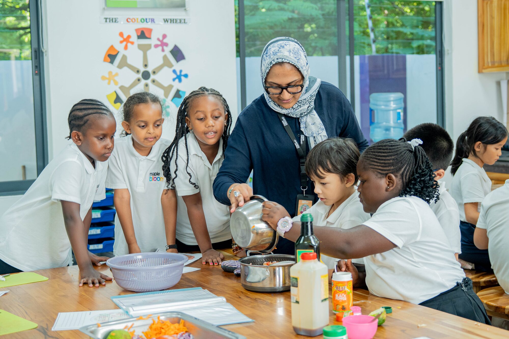 Maple Bloom teacher guiding students through a hands-on cooking class