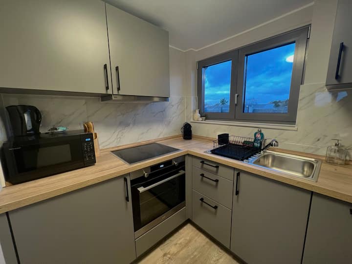 Kitchenette compacta com placa, forno e janela