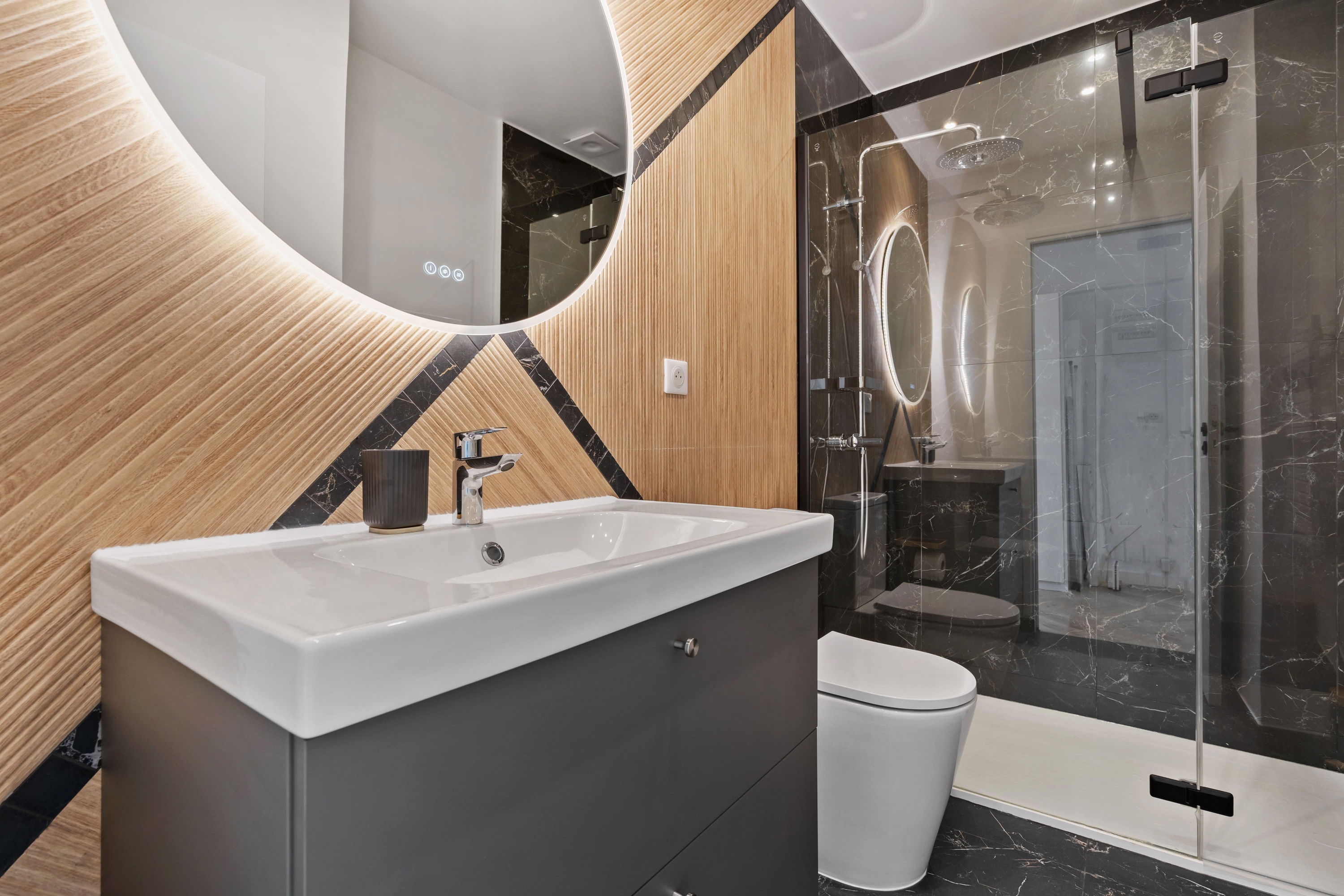 Bathroom with curved tiled wall, vanity and walk-in shower