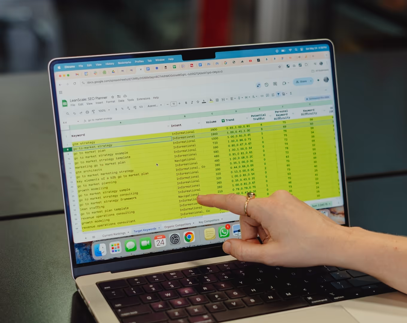 hand pointing to a detail on a laptop screen