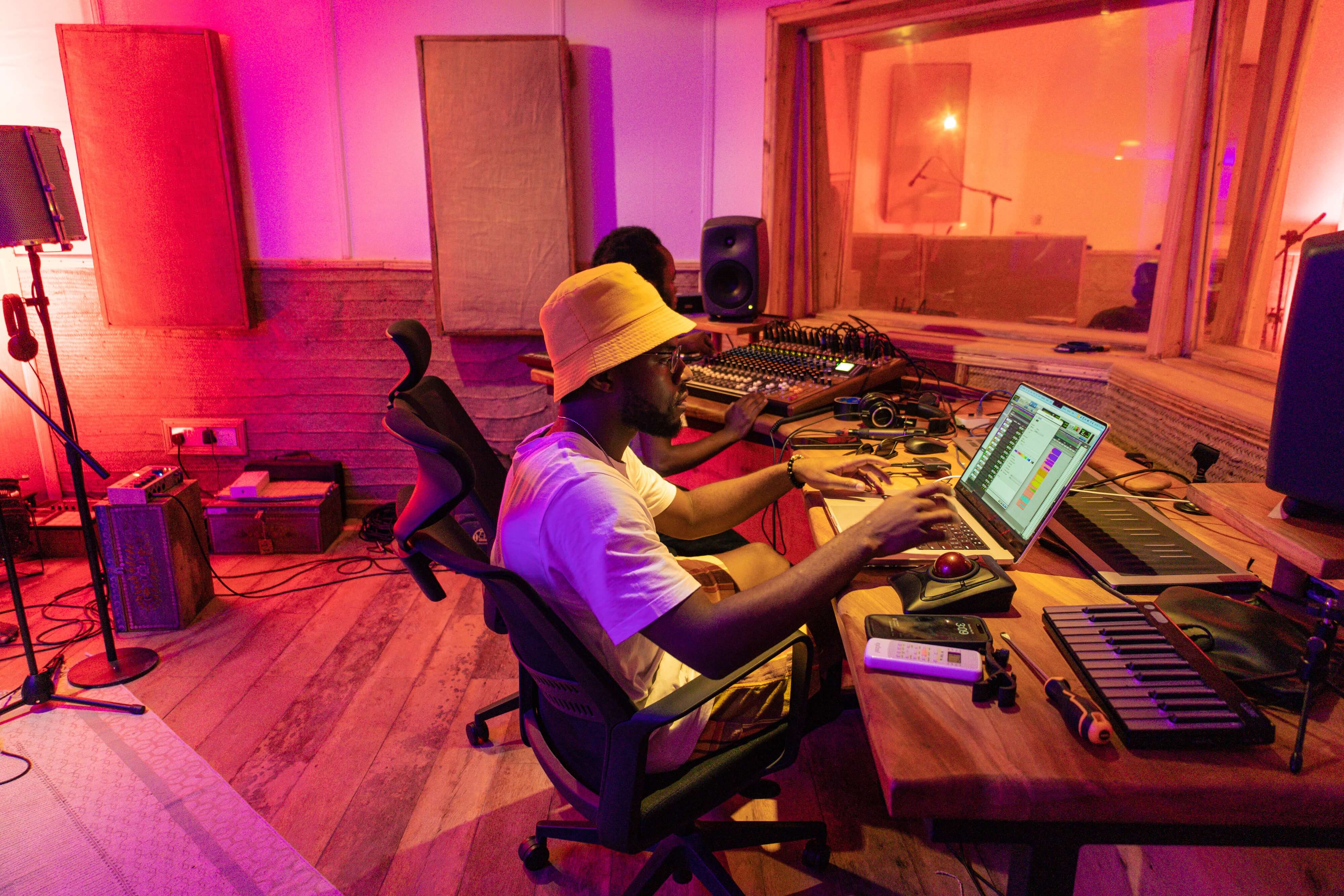 Music producer editing tracks on laptop in the control room of Baobab Studio, Kilifi