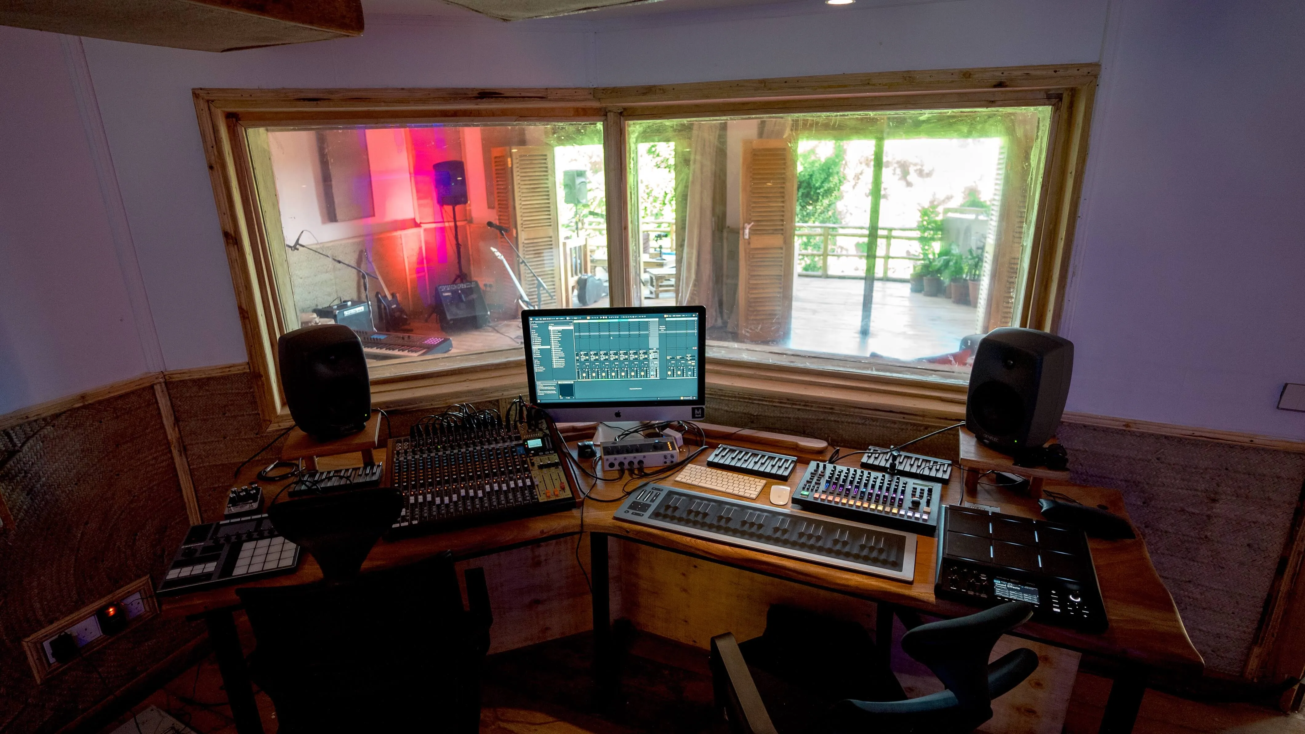 Audio production setup with mixing desk, monitor speakers, and screen inside Baobab Studio control room in Nairobi
