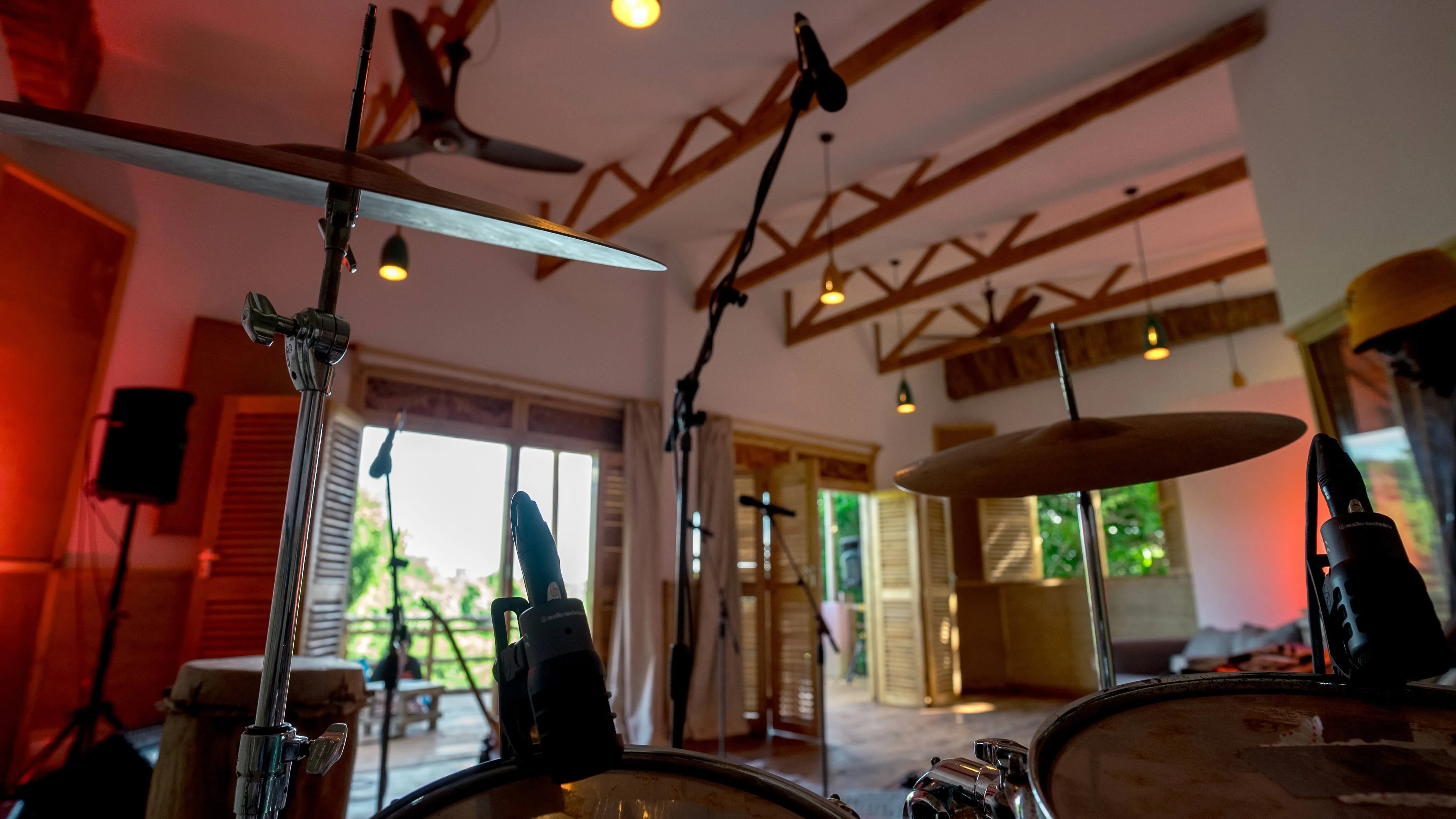 Drummer’s view at Baobab Studio showing studio gear and a glimpse of the outside through the window