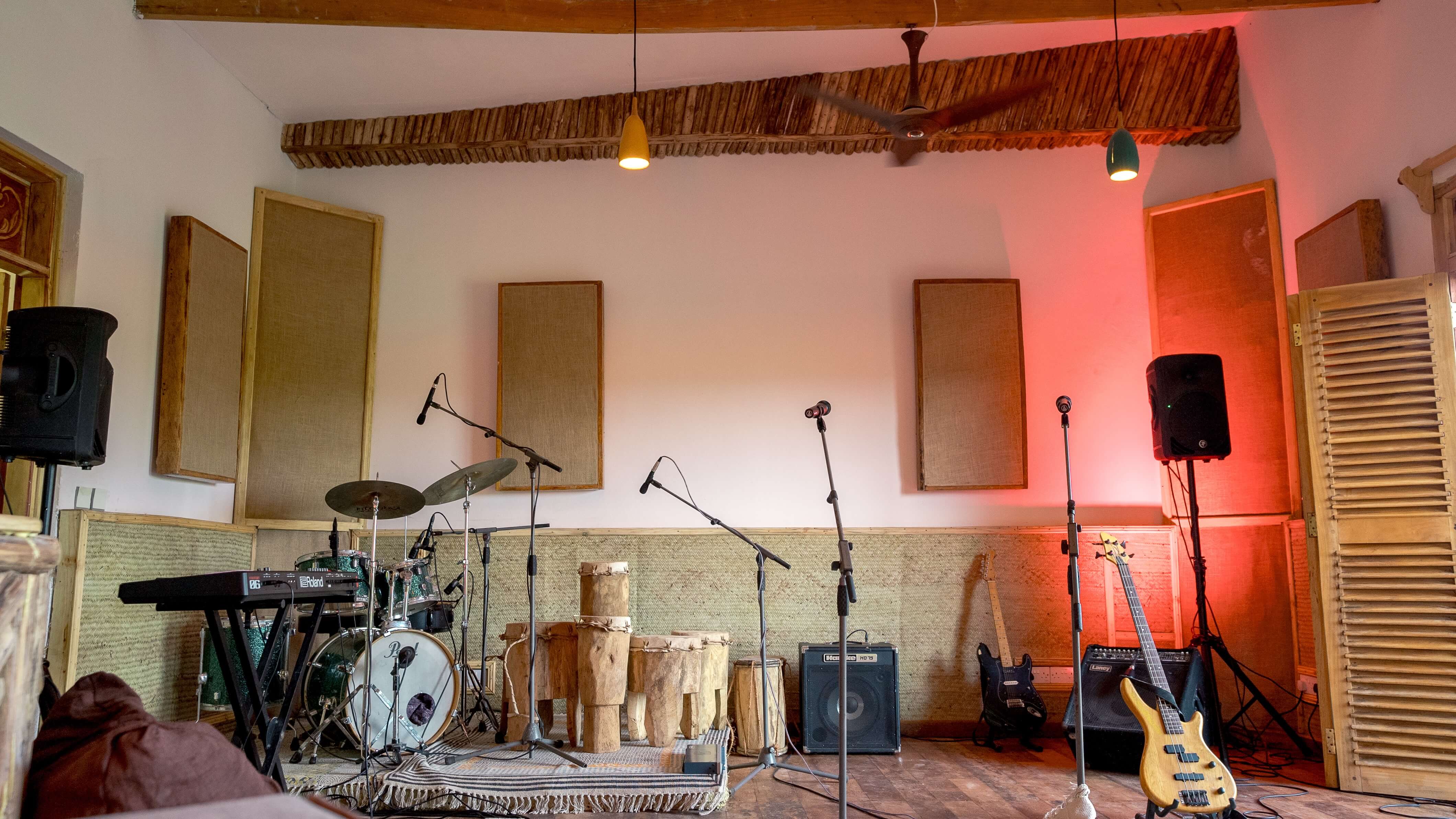 Live recording setup with drums, guitar, and mics at Baobab Studio music space in Kilifi