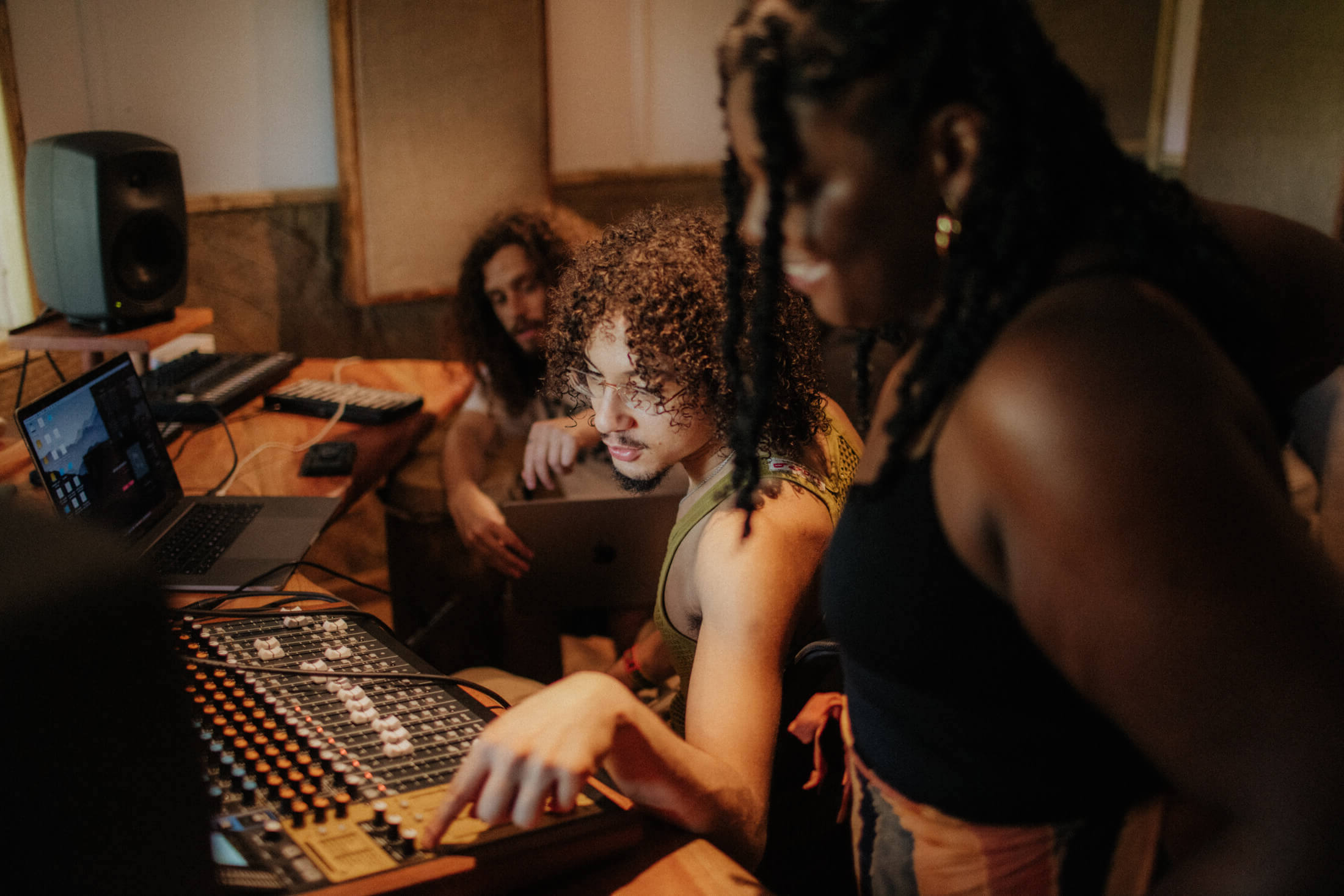 Music production session at Baobab Studio in Kilifi with a group of producers and artists around a mixing desk