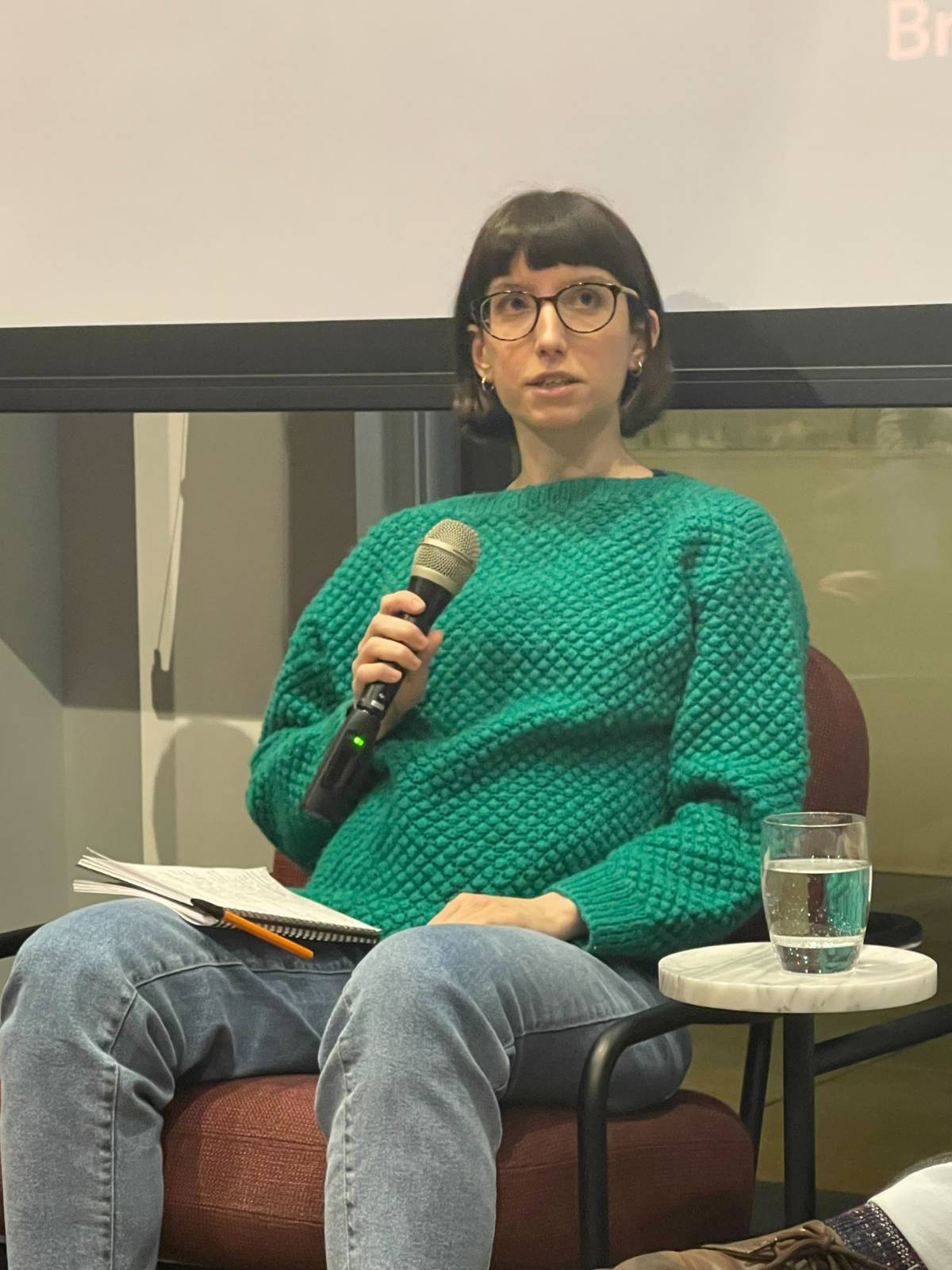 Image of Konnie holding a mic participating in a panel talk
