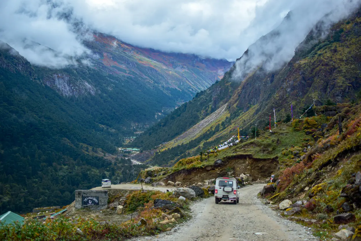 4x4 vehicle on a narrow mountain road heading towards Bum La Pass, Arunachal Pradesh