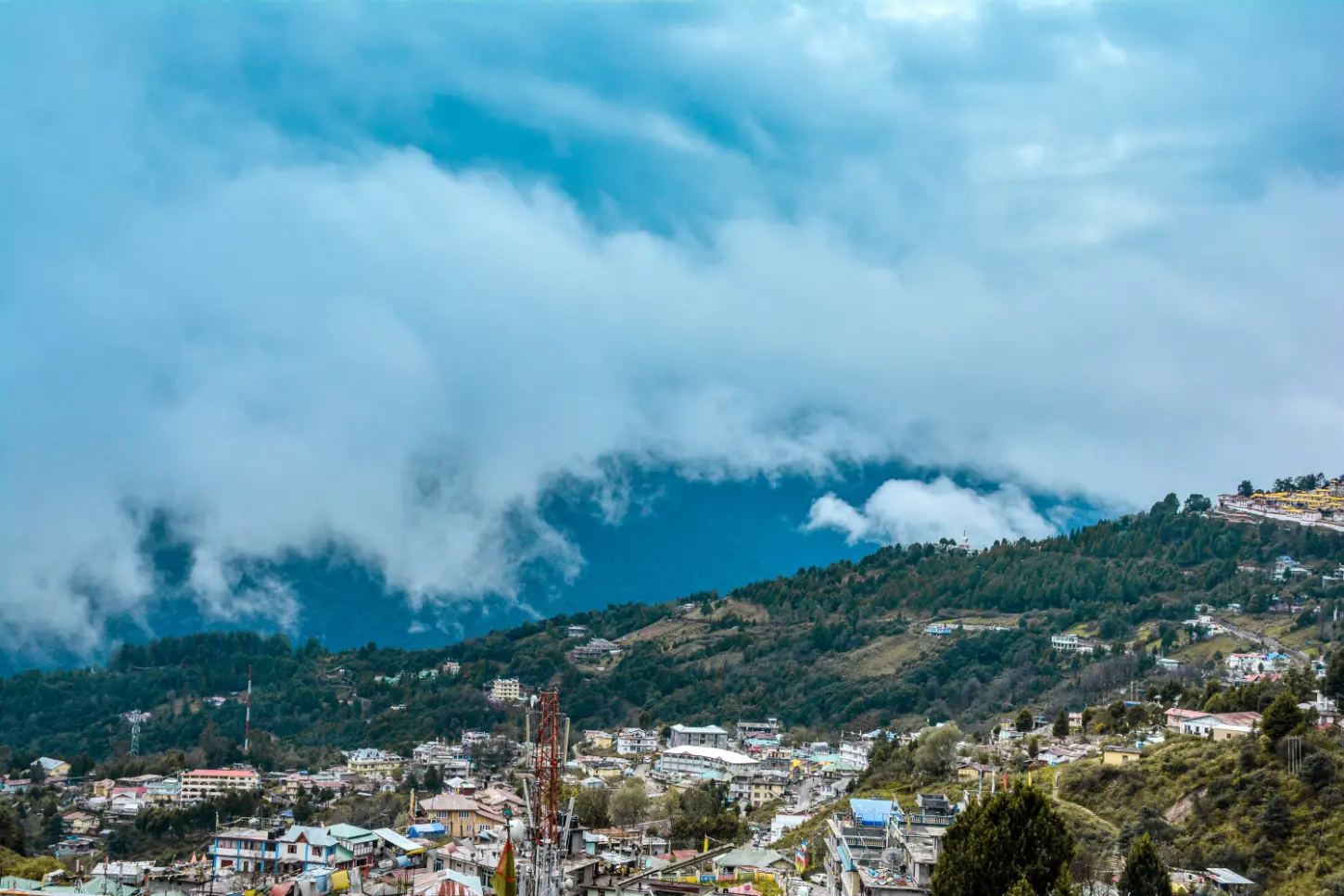 Aerial view of Tawang town with clouds rolling over the hills, Arunachal Pradesh