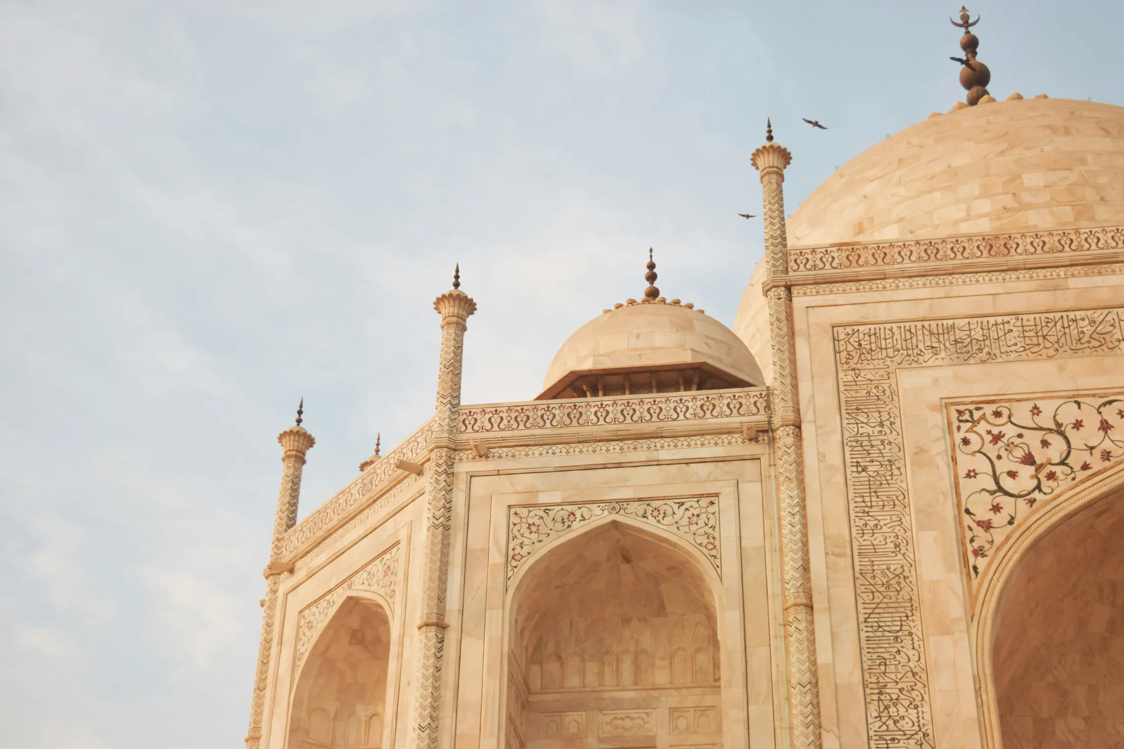 Close-up of Taj Mahal façade highlighting marble inlay work and arches