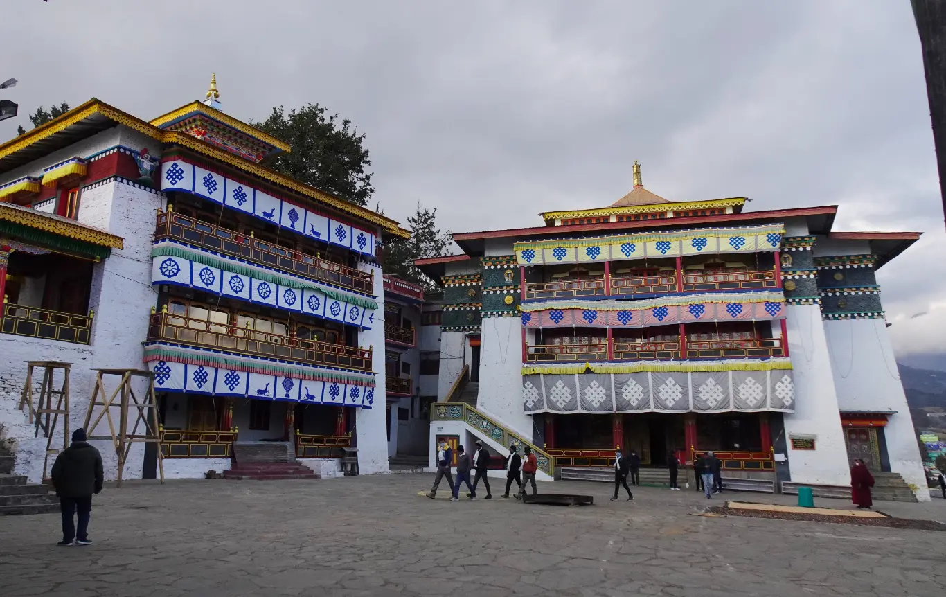 Tawang Monastery complex with traditional architecture set against a misty mountain backdrop