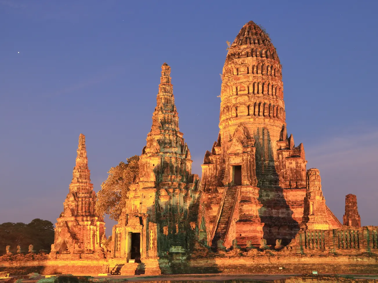 Illuminated temple ruins showcasing historic architecture in Ayutthaya at dusk