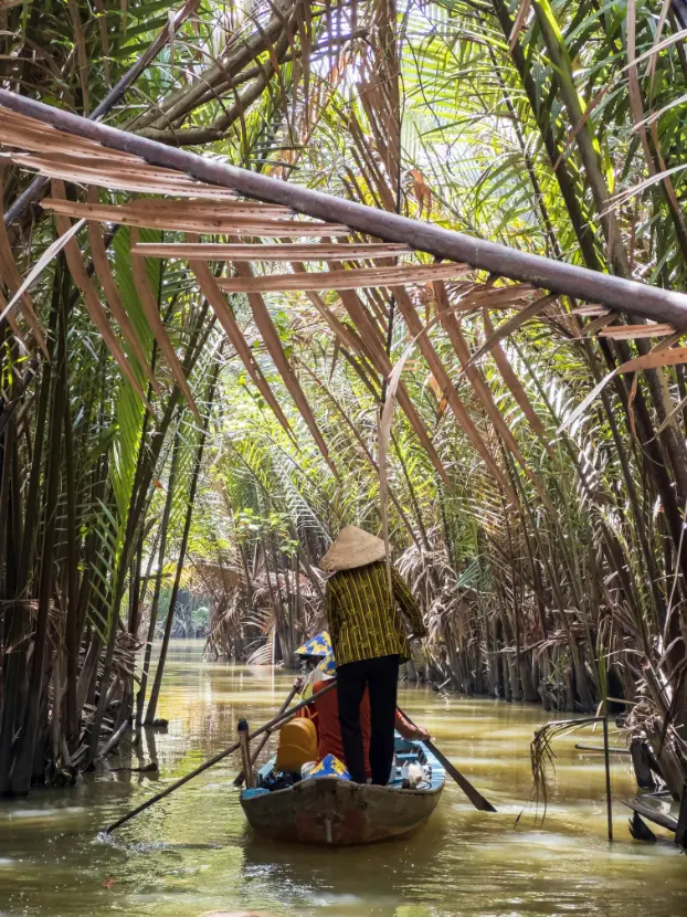 Mekong Delta small boat canal Vietnam palm trees