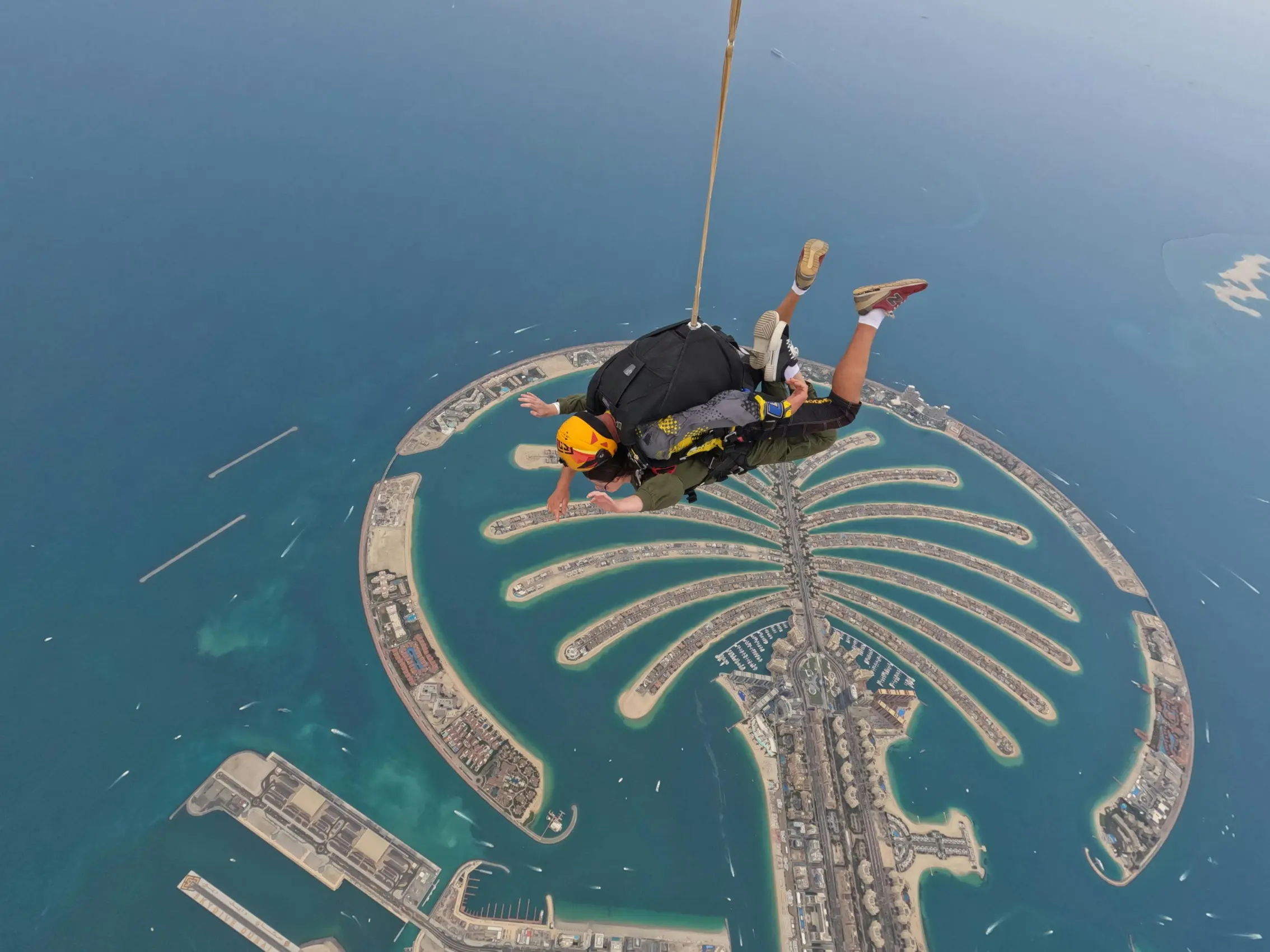 Parachute descent over Dubai Marina skyline after skydive