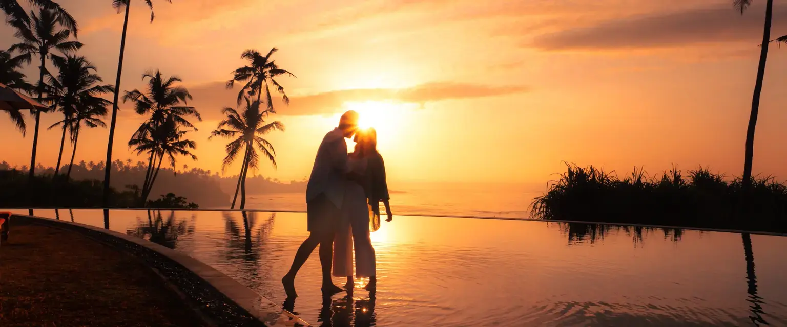Couple by the infinity pool at Cape Weligama overlooking the Indian Ocean in Sri Lanka