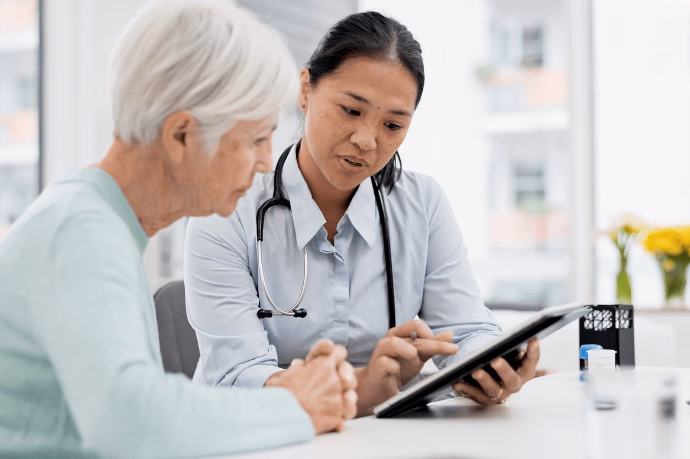 Nurse discussing a serious condition with a senior patient during a medical consultation, highlighting care from the best neurosurgeon in Los Angeles.