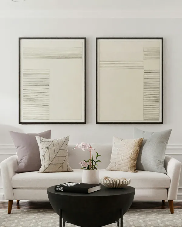 Two pieces of art above sofa