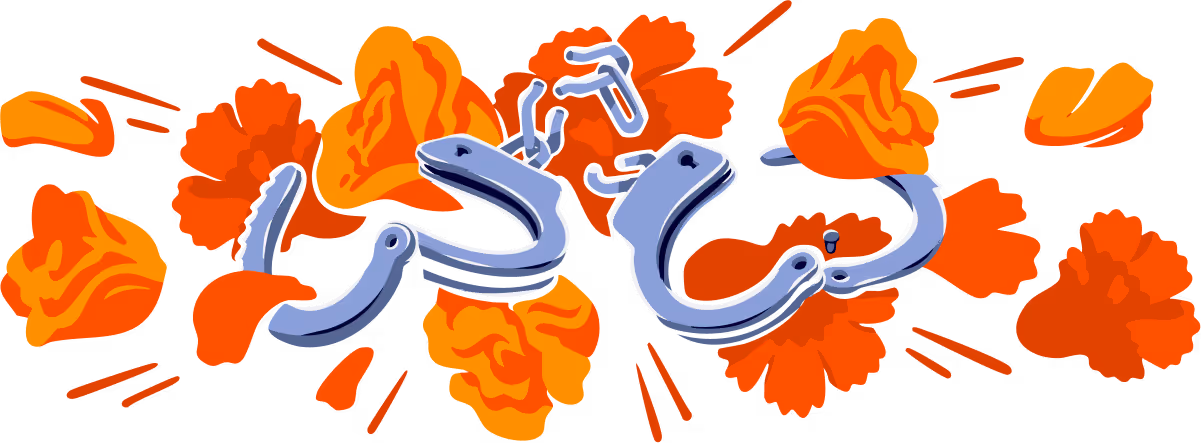 A pair of broken, open handcuffs in front of red and orange flowers