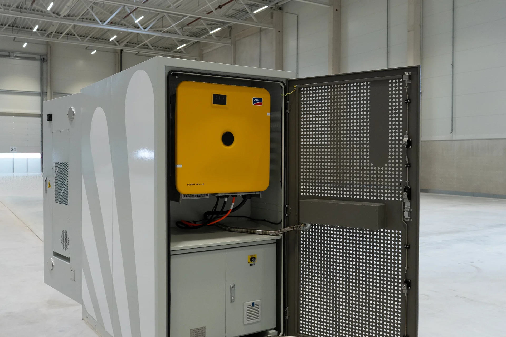 PHENOGY battery cabinet with the door open, showing the inverter inside