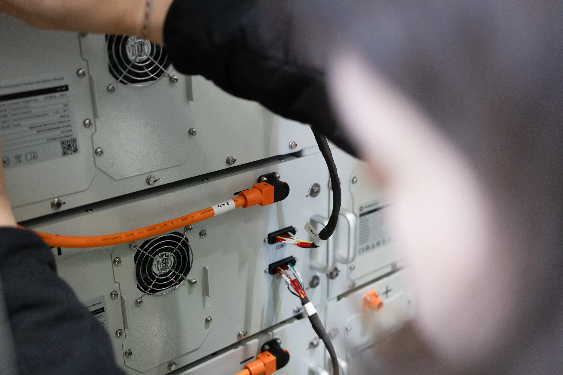 Technician connecting a DC cable to a PHENOGY battery module