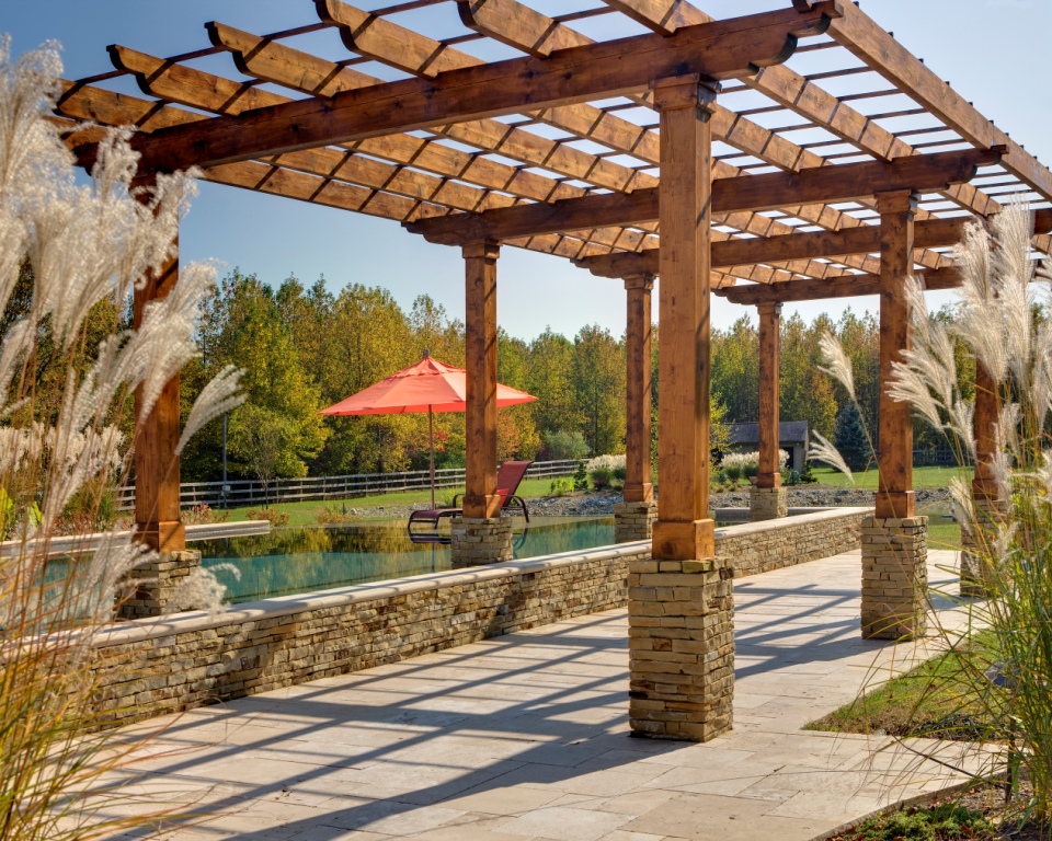 Cedar pergola framing the entry to a mirror-still reflecting pool, Monroe, NJ
