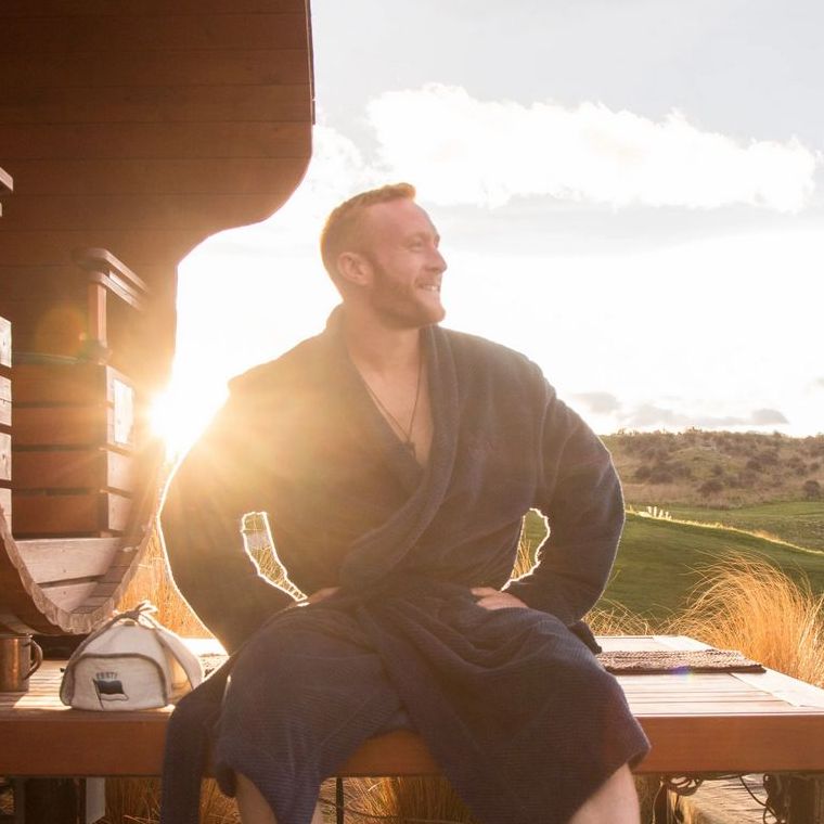 Rick sitting on the deck outside a sauna