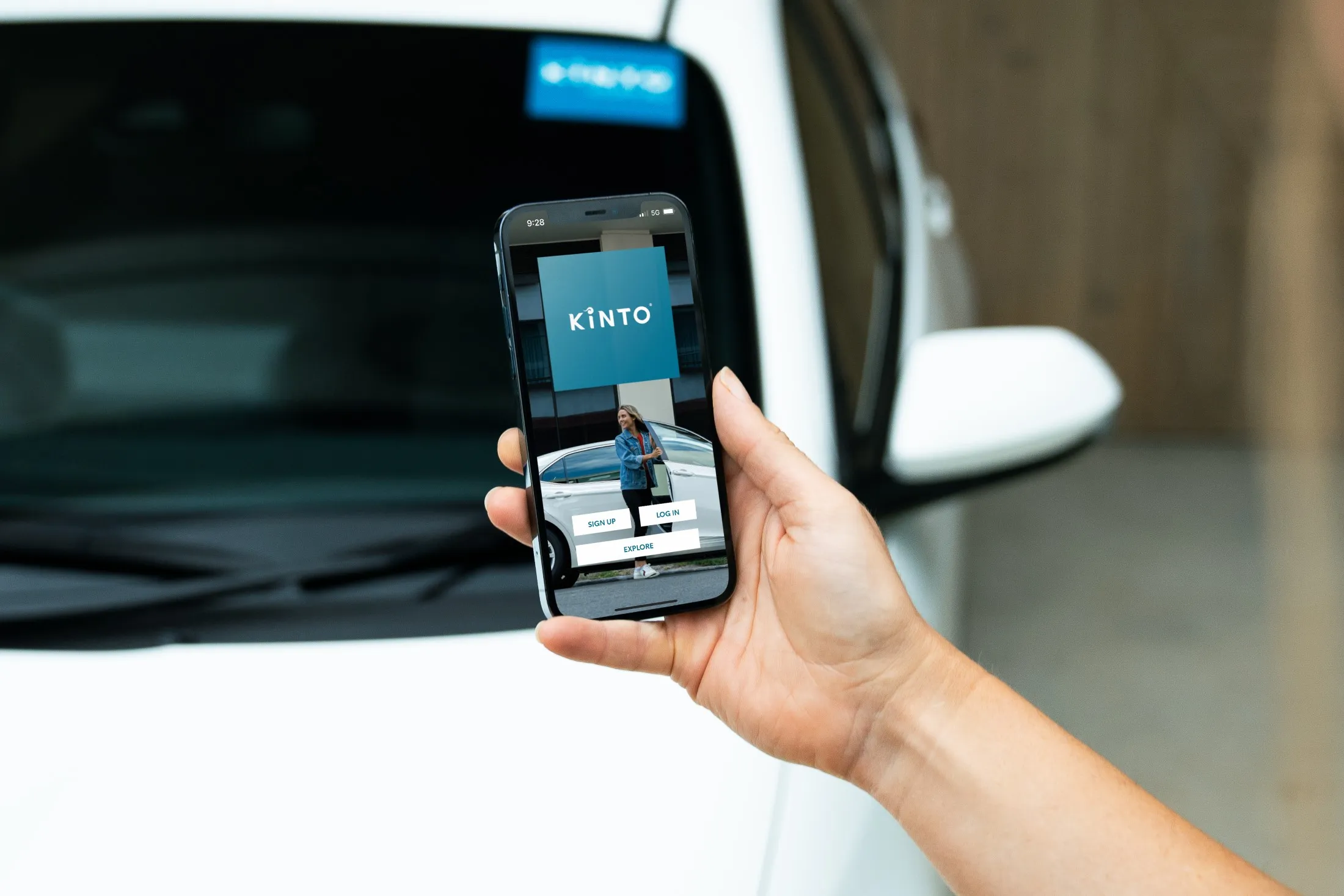 KINTO car rental Residential holding phone with KINTO app