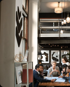 A group of people sitting around a wooden table.