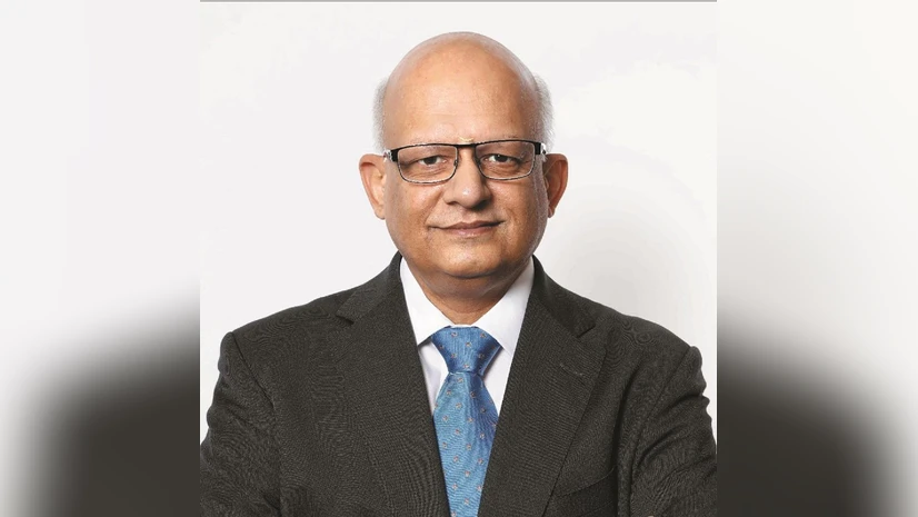 Mature professional in glasses and suit with blue tie, looking forward
