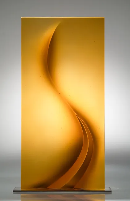 Amber glass sculpture photographed in a studio setting