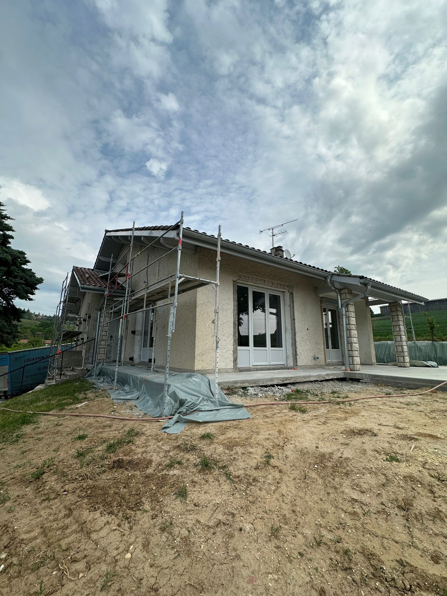 Maison en chantier d'isolation thermique par l'extérieur à Saint-Jean-en-Royans avec échafaudage par DLS Facade.