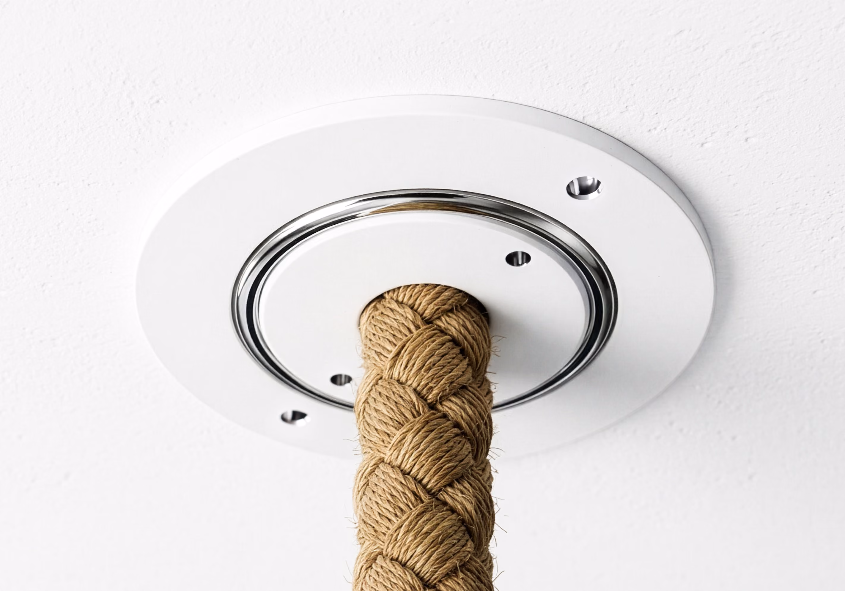 Braided rope attached to a white ceiling mount with a chrome ring and screw holes.